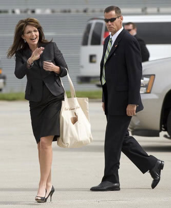 Was1970440 Sarah Palin waves as she arrives in Pennsylvania on Oct. 8. Her bag says "Real Women Hunt Moose." Photo by Jim Watson/AFP/Getty Images.