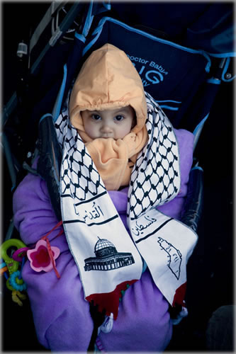 Child of anti-Isreali protestors in Paris yesterday is bundled against the cold. Demonstrations against Israel's bombing and invasion of the Gaza Strip have erupted around the world. Photo by Dani Voirin. Child of anti-Isreali protestors in Paris yesterday is bundled against the cold. Demonstrations against Israel's bombing and invasion of the Gaza Strip have erupted around the world. Photo by Dani Voirin.
