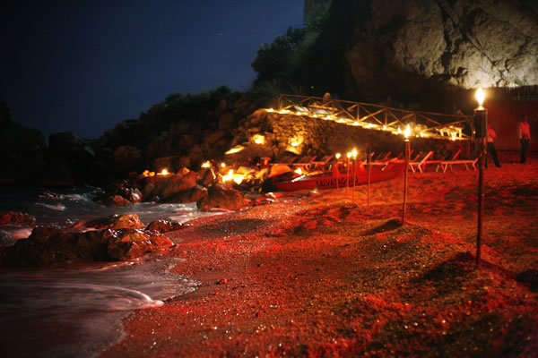 A night in Taormina, on the east coast Sicily. A beach lit by candlelight. Photo by Dani Voirin. 