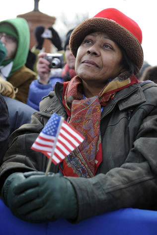 A supporter listens to President-elect Obama at a rally in Wilmington, Del., during his whistle-stop tour Saturday. KEVIN DIETSCH – BLOOMBERG NEWS PHOTO
