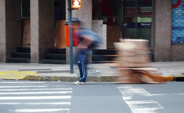 boy-dragging-boxes-in-san-telmo Just a boy dragging a stack of cardboard boxes down the road in Buenos Aires. Photo by Dani Voirin.