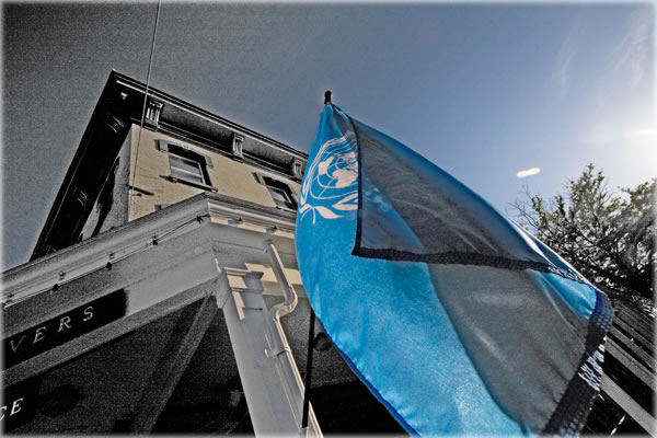 United Nations flag flies outside Dominick's CafГ© in Kingston, New York. Photo by Eric Francis.