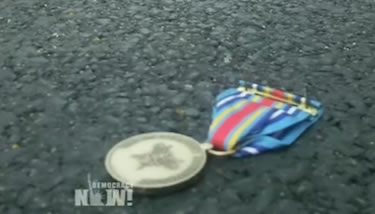 Medal flung in the direction of the NATO summit in Chicago by a veteran or the Iraq or Afghanistan war. Image taken from video.