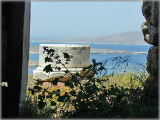 Planet Waves. View from inside the Cave of Kynthos, place of worship of Heracles, on the sacred isle of Delos, with its view of the ancient harbor. Delos, near Mykonos, was the mecca of the Greek world between the 7th and 1st centuries BCE. The first cosmopolitan center of Europe, the island has laid in ruins since it was sacked in 69 BCE. Photo by Eric Francis.