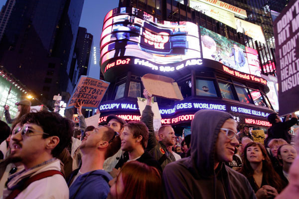 Breaking story -- ABC News ticker informs protesters at Times Square in New York City on Saturday, Oct. 15 that the #Occupy movement has gone global. Photo by Eric Francis.