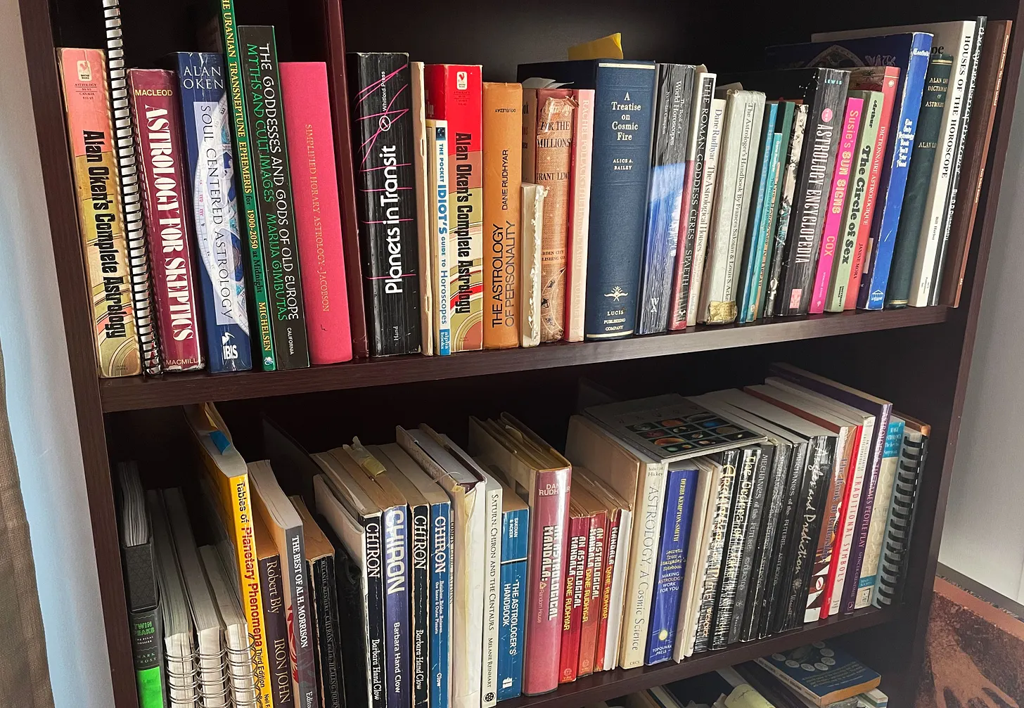 Astrology books on a bookshelf.