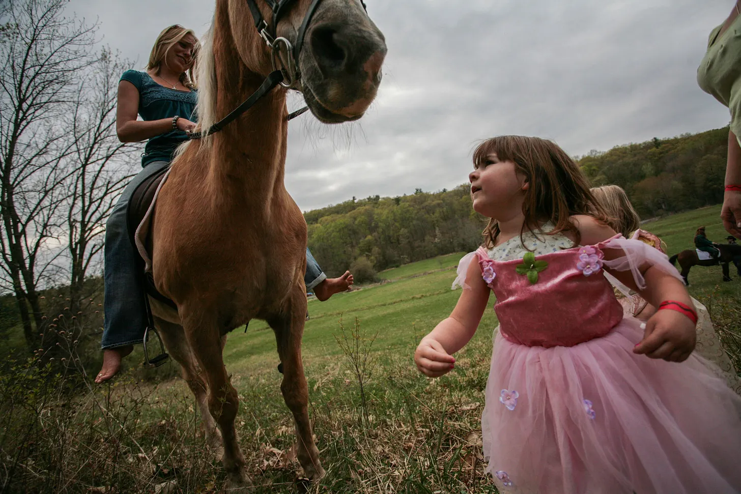 Woman on horseback and small child at Beltane 2008.
