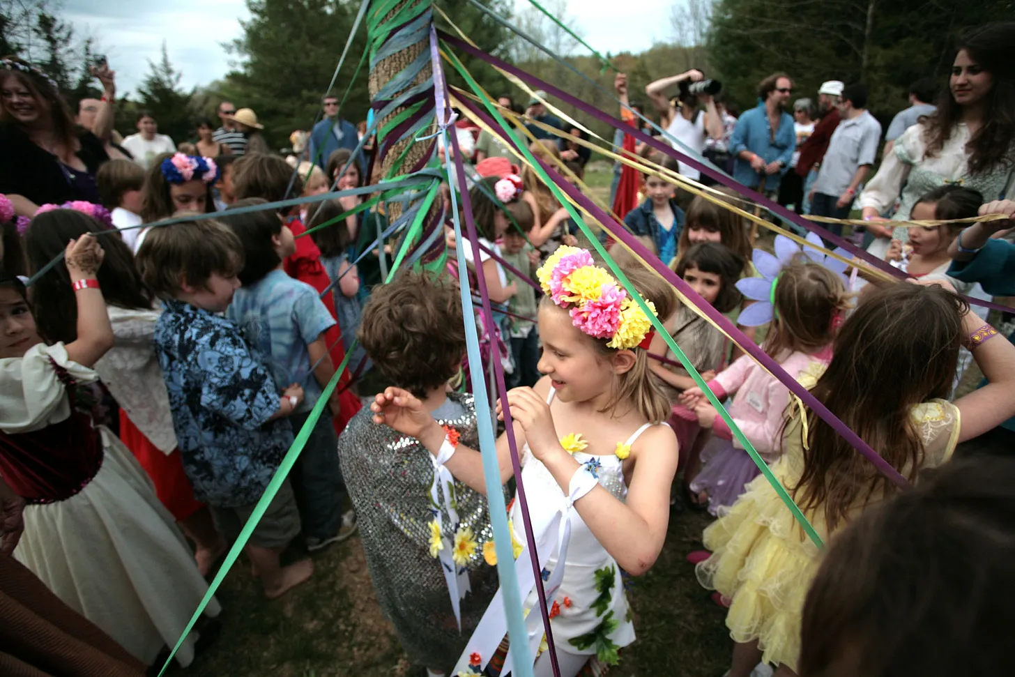 Children dancing around the maypole at Beltane.