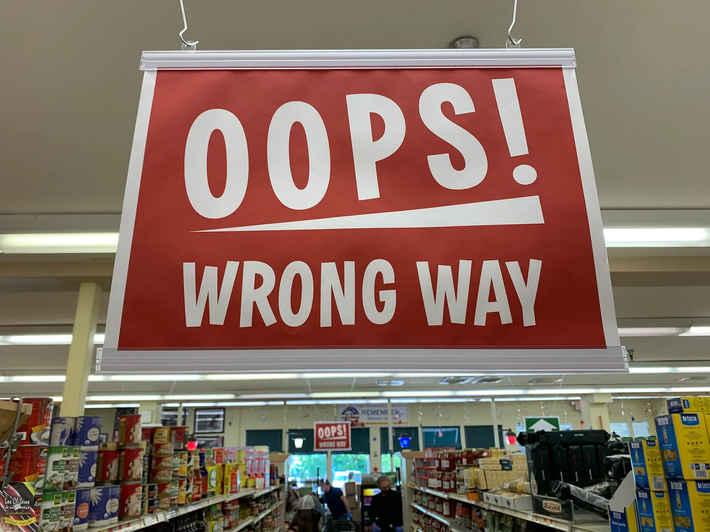 Supermarket sign reading "Oops! Wrong Way" 
